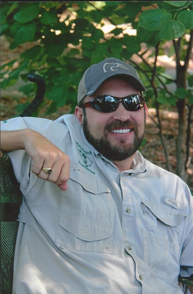 Michael Wood, owner of McCormick Insurance Agency, seated outdoors
